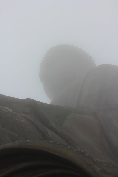 Big buddha still trapped in the  fog at the very top