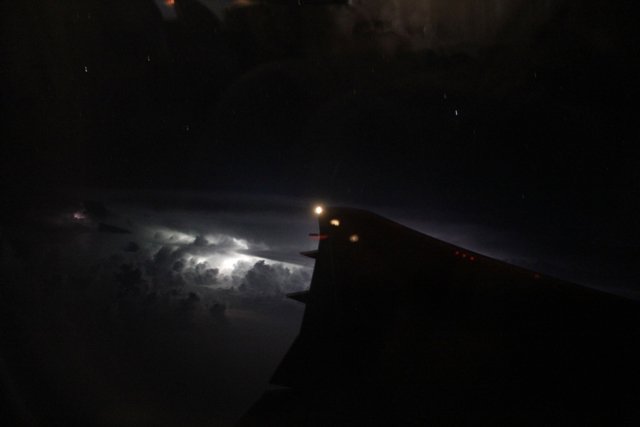 Lightening in the distance, looking out the plane window