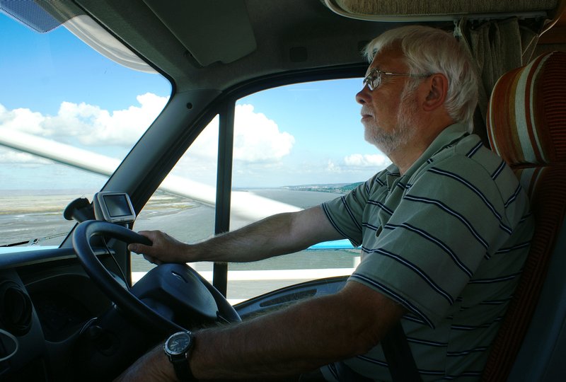 Bob totallyl relaxed as he drives over the bridge