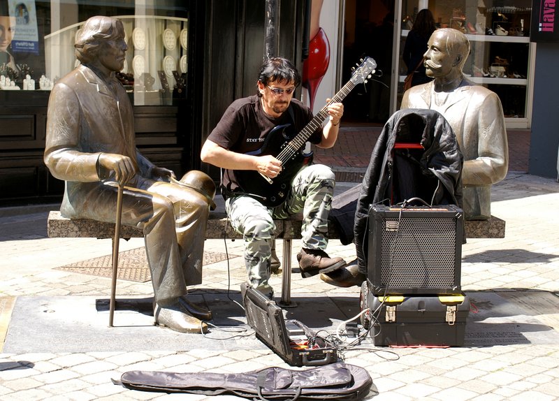 Busker and his stony faced mates