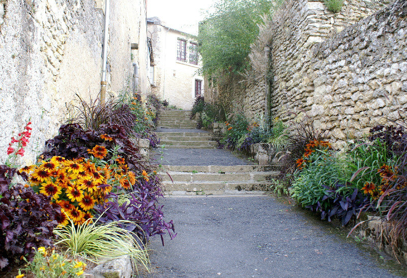 The floral decorated steps down from the town to the river walk