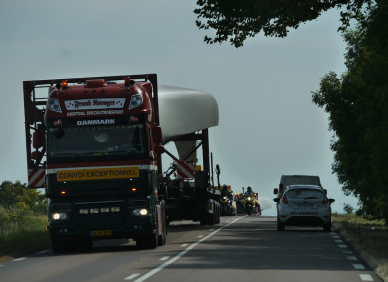 This is why we don't like wind turbines. I know we need electricity. But.... there were 4 trucks like this, about 12 escort vehicles, a half kolomtre traffic jam behind .... to transport just 1 turbine into place. Just how does that lot balance out with t