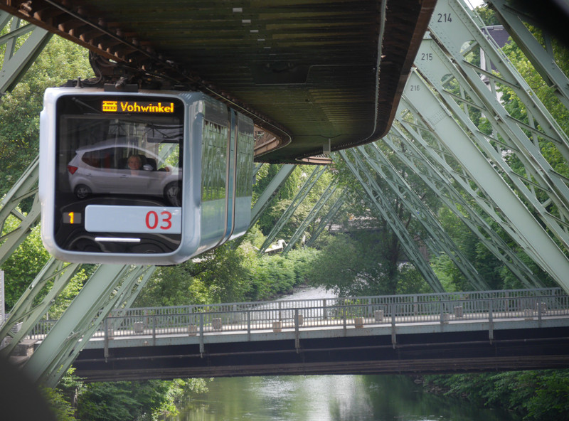 Wuppertal suspension train with a car from the road below reflected in the front