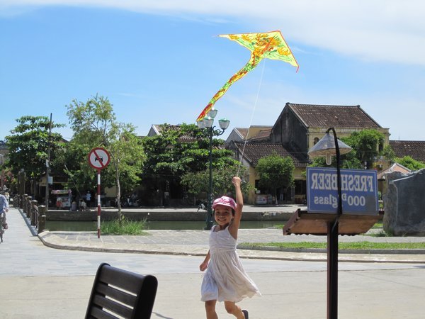Girl flying kite in Hoi An
