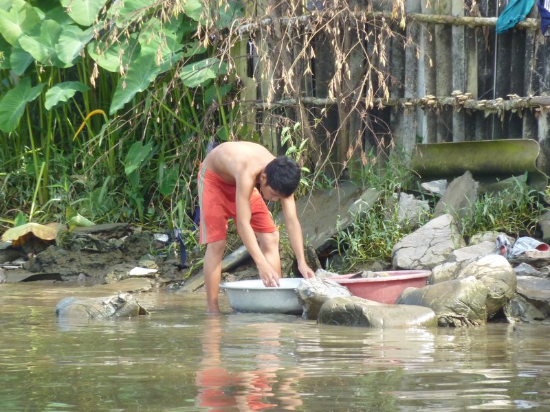 Washing clothes, in the river