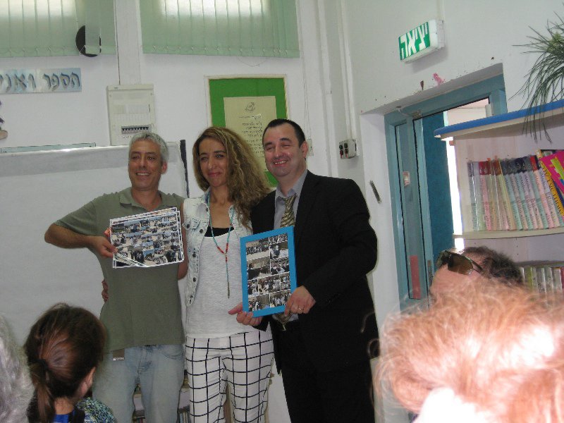 Nirim School presents photo booklet of Bar Mitzvah to Rabbi Nof