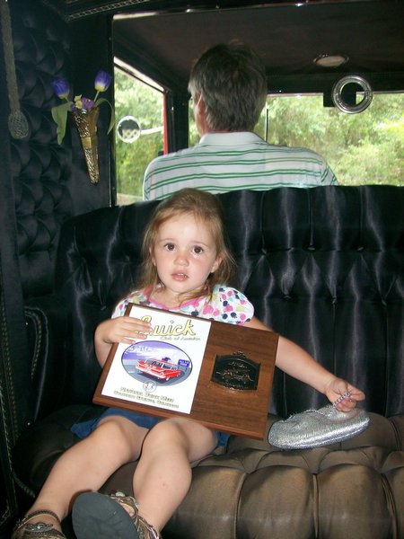 Lorelei holds the Grand Nationals plaque for 1933 Buick Bronkhorst Limo