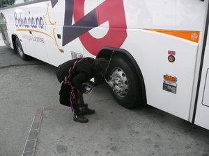 Linda inspects the tyres of the bus