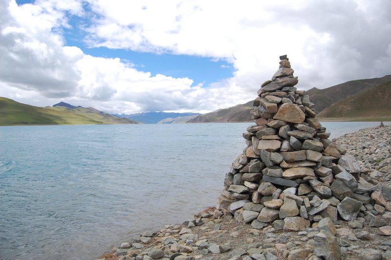 Stones are piled in front of the lake
