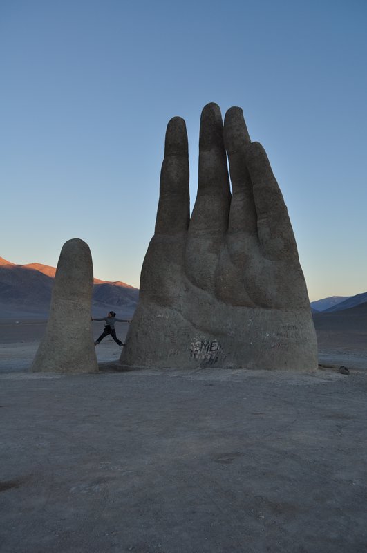 A random giant hand in the desert.
