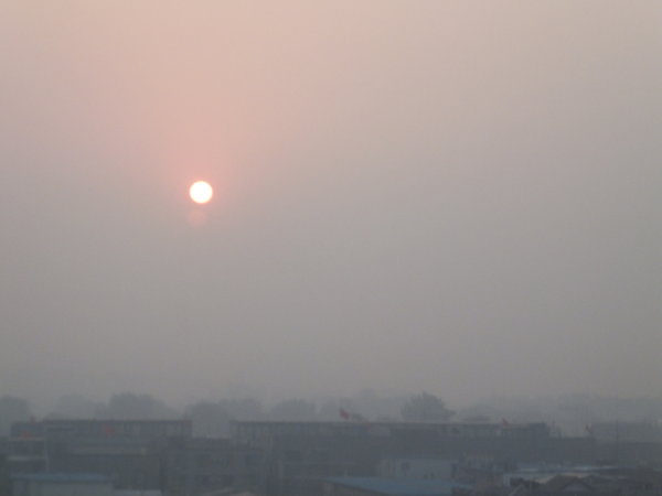 Blood orange sun tries to shine through Beijing smog