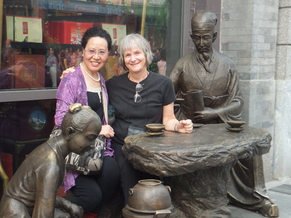 Karen posing with Chinese friend in front of tea shop on Qiam Men Jie