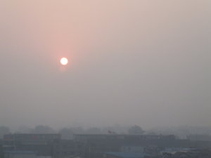 Blood orange sun tries to shine through Beijing smog