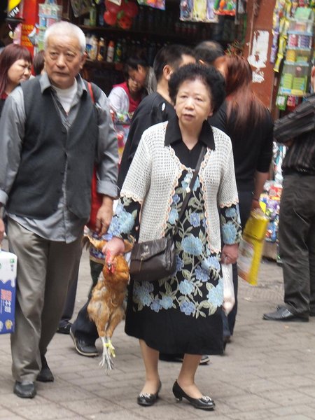 She's carrying that chicken home from the market