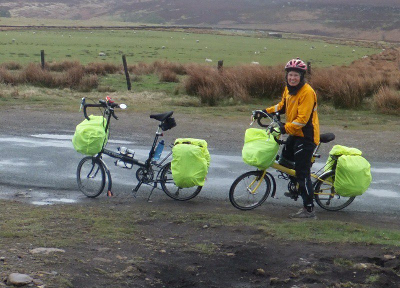 A rest stop, showing the Bike Fridays, and Kathy, decked out for rain