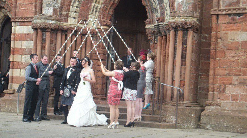 Arch of pitchforks in wedding at St Magnus Cathedral