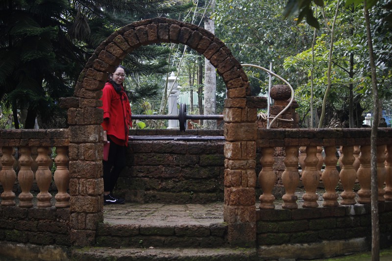 Ms. Lan at the legendary Buddhist well at Thien An Pagoda