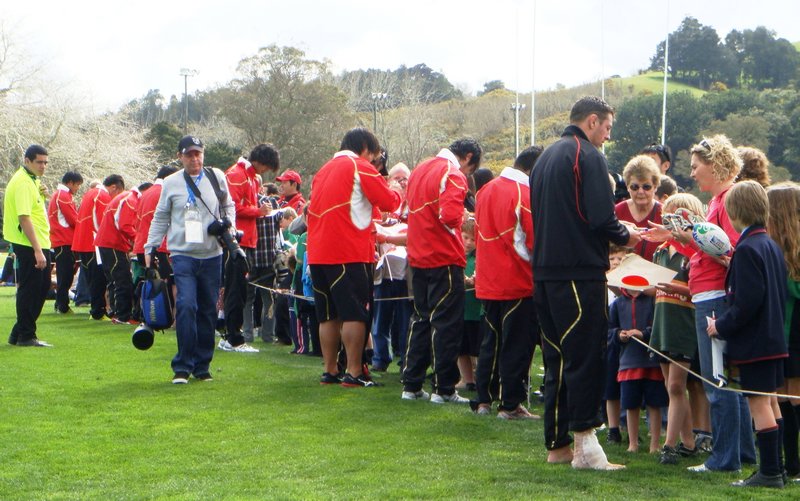 Players sign autographs at the open training session