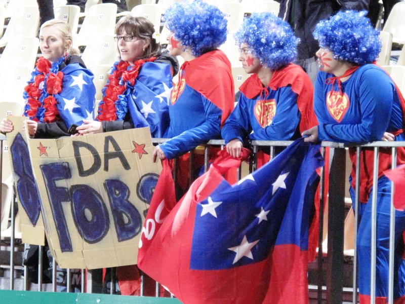 Samoan fans wait for their team to pass by