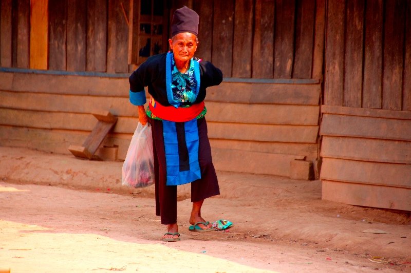 Village elder selling embroidered bags