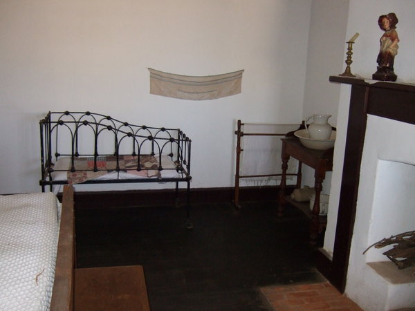 A cot for the fourth child in this bedroom with Mum and Dad