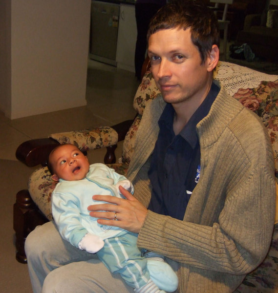 Dad, David, proudly holds his beautiful three week old baby, Micah 
