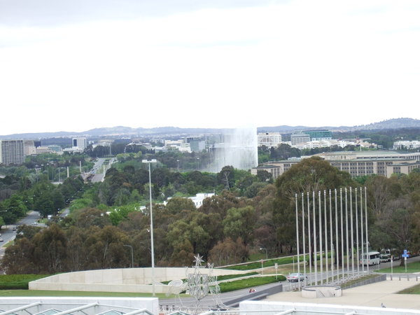 The spray from the fountain in Lake Burley Griffin rises above the buildings  