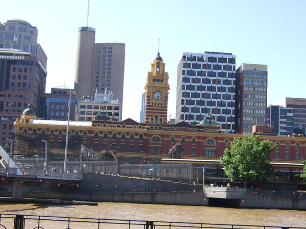 Across the Yarra River historic Flinders Street Station stands out among the modern skyscrapers