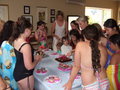 Everyone gathers round as Anna lights the birthday cake