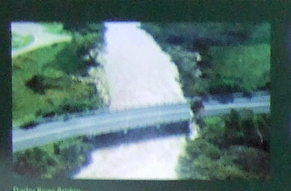 The damaged bridge over the swollen Darby River