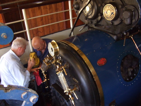 Two enthusiasts lovingly tend the sparkling engine