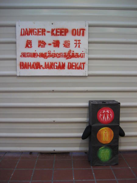 Bobby with English, Chinese, Tamil and Malay Danger Sign