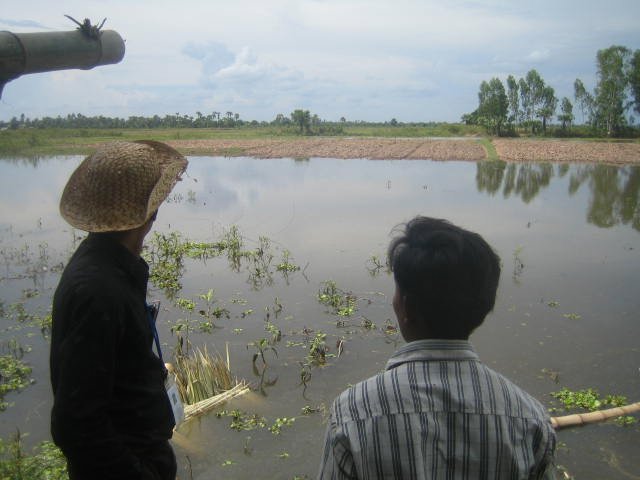 Kuan & Sameth looking over the flooded rice fields where my wells are situated 