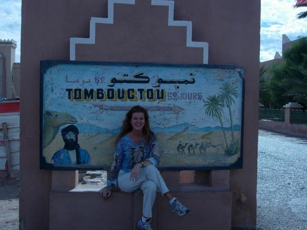Sign reads "52 days to Timbuktu" (by camel)