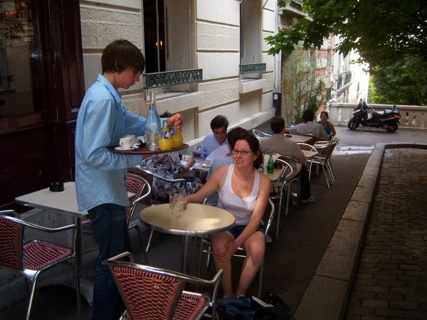 Kristy being served in a Paris cafe