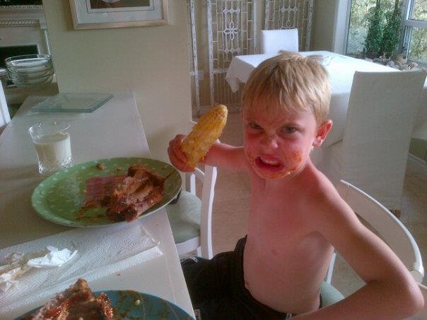 Cooper eating his fav...ribs and corn