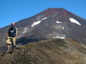 Barry on rim of Crater Navidad with Volcan Lonquimay in background