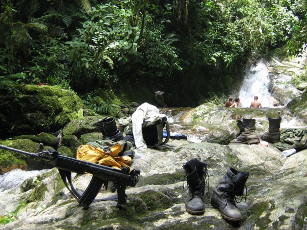 Colombian soldiers bathing near Ciudad Perdida, having left their guns and boots on the nearby rocks
