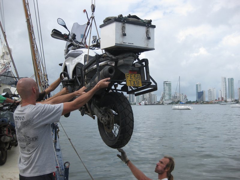 Off loading a big bike into a little dingy.