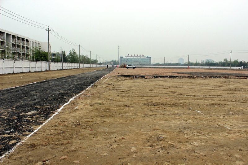 Cleared ground, near the school