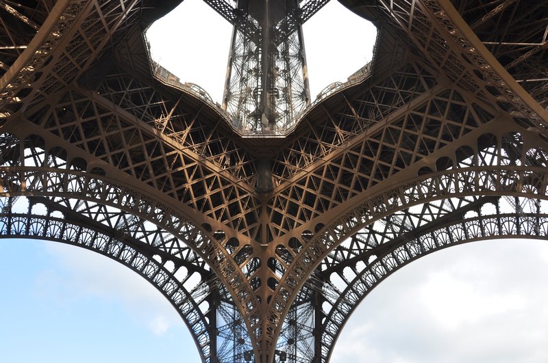 Looking up at The Eiffel Tower during the day.