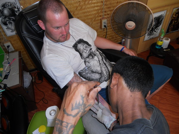 Lee getting a tattoo