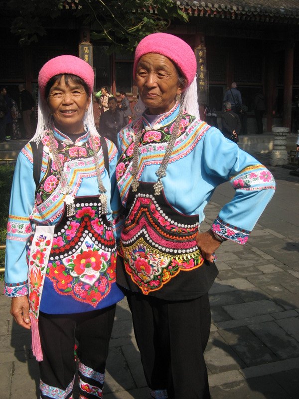 Two Chinese women modeling their outfits