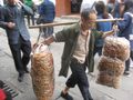 Man carrying bags of deep fried donut chips
