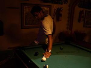Raj plays pool, smoothly