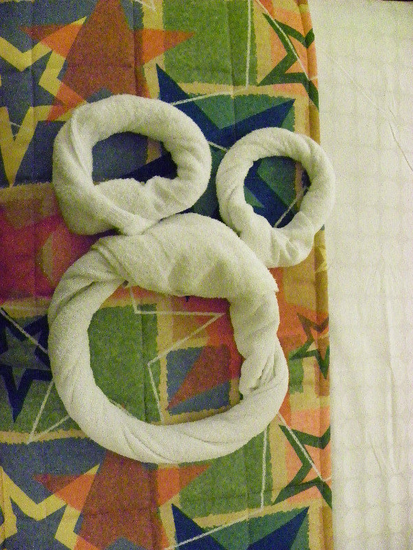 Mickey-shaped towels on the bed