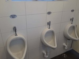 Pub's urinals labeled German Beer, Irish Beer, and Alcohol-free