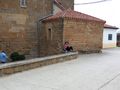Manoli sitting near the church in Zariquiegui, a scene from The Way