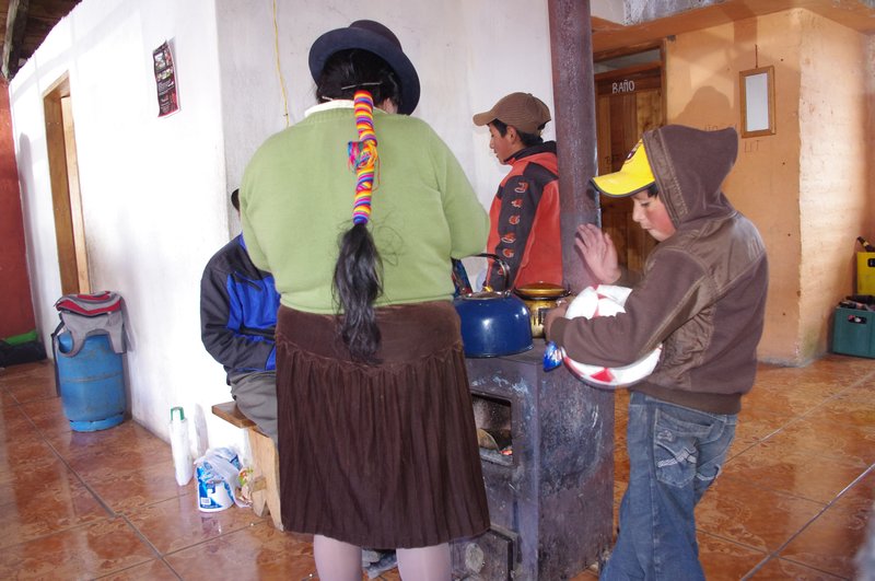 Andean woman making our first cup of coffee in Quilotoa