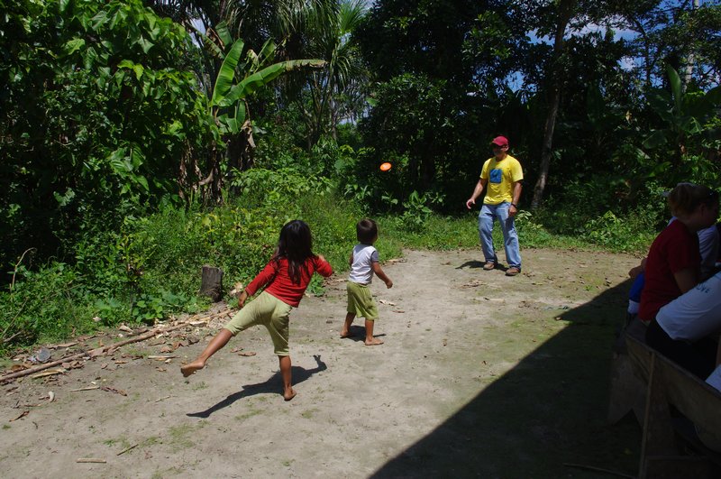 Paul playing frisbee with the children